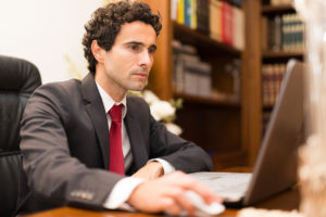 Funeral Director Working on Laptop Computer