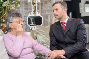 Woman Consoled By Funeral Director